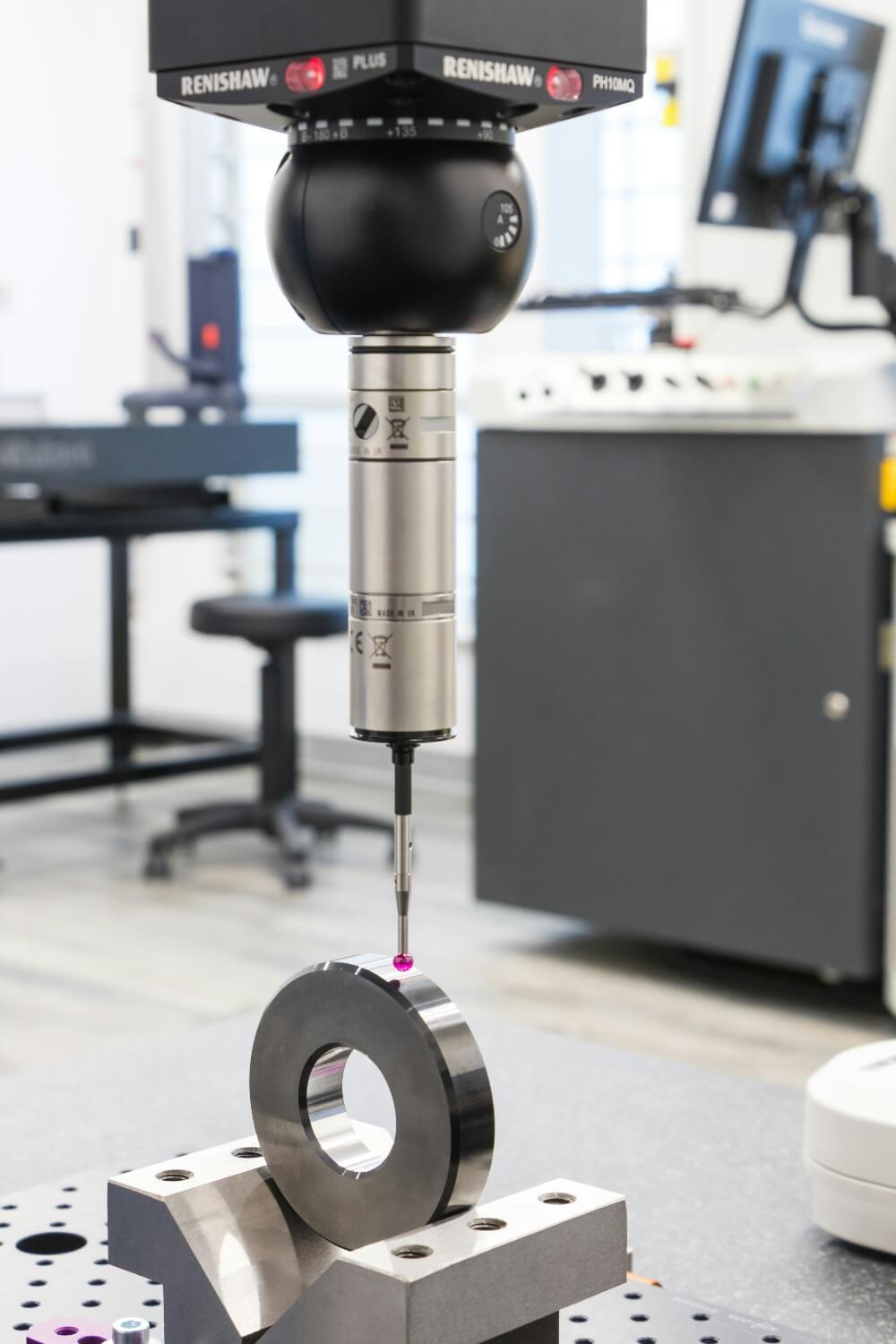 Sonda di misura Renishaw che verifica le dimensioni di un componente metallico.